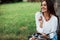 Sincere emotions. Young woman have weekend and sits in the park at daytime