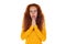 Sincere redhead woman holds hands together praying pose