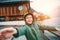 Sincerely smiling boy near the bot pier on mountain lake