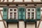 Sindelfingen, Baden Wurttemberg/Germany - May 11, 2019: Two colorful wooden windows on a traditional half-timbered house facades