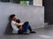 SINGAPORE - 5 APR 2019 - An exhuasted man sleeping on the sidewalk outside a shopping mall in the afternoon