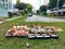 Singapore Aug2021 Lavish spread of food and drinks with joss paper, incense placed on grass in neighbourhood heartland as