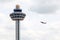 Singapore Changi Airport Traffic Controller Tower With Plane Takeoff