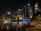 Singapore City skyline at night, dazzling lights illuminate the skyline, reflecting on the waters