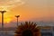 Singapore. March 2019. Airport lighting towers and orange cloudy sunrise at Changi International Airport. Lamp tower of spotlights