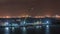 Singapore Marina Barrage with cargo ships waiting to enter one of the busiest ports in the world night timelapse