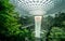 SINGAPORE-OCTOBER 19, 2019 : HSBC Rain Vortex, the world`s tallest indoor waterfall at Jewel Changi Airport. Green forest in mall