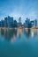 Singapore`s business district at twilight with water reflection