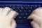 Singapore - SEPTEMBER 30, 2019: blue asus laptop fingers hand press type fast double exposure typing