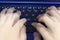 Singapore - SEPTEMBER 30, 2019: blue asus laptop fingers hand press type fast double exposure typing