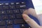 Singapore - SEPTEMBER 30, 2019: blue asus laptop fingers hand press type fast double exposure typing enter blur