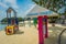 SINGAPORE, SINGAPORE - FEBRUARY 01, 2018: Unidentified people walking in the beach and informative sign with pink