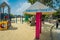 SINGAPORE, SINGAPORE - FEBRUARY 01, 2018: Unidentified people walking in the beach and informative sign with pink