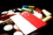 Singaporean flag with lot of medical pills isolated on black background
