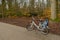 Singe white blue bike standing side view outside in the woods. Autum winter trees background.