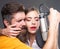 Singer couple singing rock. Sound producer recording song in a music studio. Sexy man and woman singing with music