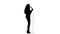 Singer dances to the beat of her song. White background. Silhouette. Side view. Slow motion