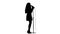 Singer dances to the beat of her song. White background. Silhouette. Side view. Slow motion