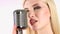 Singer sings in a retro microphone. White background. Side view. Close up