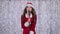 Singer in a snow maiden costume sings songs in a retro microphone. Bokeh background