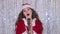 Singer in a snow maiden costume sings songs in a retro microphone. Bokeh background. Close up