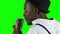 Singer the view from the back holding his microphone and gesticulating hands sings. Green screen. Close up