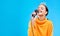 Singer woman, crown and microphone in studio mockup with smile for singing performance by blue background. Happy gen z