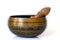 Singing bowl close-up, soothing and meditative. Singing bowl with sanskrit engraving pattern and wooden mallet Isolated on white