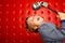 Singing boy with microphone on rack against wall