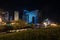 Singing light and music fountain on background of panorama of beautiful buildings at night