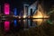 Singing light and music fountain on background of panorama of beautiful buildings at night