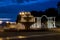 Singing three-tiered fountain and arch with columns on the background of the sunset sky. Gelendzhik embankment in the