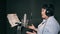 Singing woman in a recording studio. Adult woman recording a song in a recording studio.