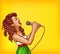 Singing young woman with microphone pop art vector