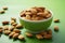 Single almond in a white ceramic bowl on green background, promoting healthy eating