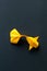 Single alone handmade paper craft origami gold or yellow koi carp fish on black background.Top view, centeral plece