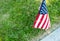 A single American flag placed at a veteran`s gravesite marker