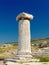Single ancient column against clear blue sky