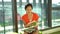 Single asian Chinese woman reading and flipping books by the window