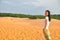 Single Asian girl looks to camera on sand dune