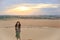 Single Asian girl smiling to camera on sand dune