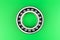 Single ball bearing close up, isolated on green background with copy space on the sides.