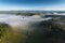 A single balloon floating over foggy ground