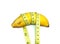 Single Banana Surrounded by Measuring Tape on White Background