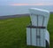Single beach chair on green meadow
