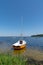 Single boat orange and white in blue water lake in Lacanau Gironde in France