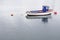 Single boat red and blue rustic wooden at sea marina moored