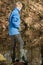 Single boy in blue jacket at pond fishing alone