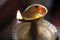 Single burning flame in a brass oil lamp