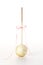 Single Cake Pop Decorated With Gold Sprinkles And A Ribbon On A White Background.